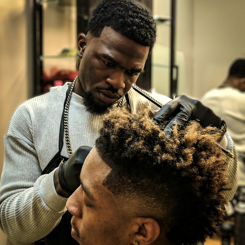 Barber working a fade with clippers